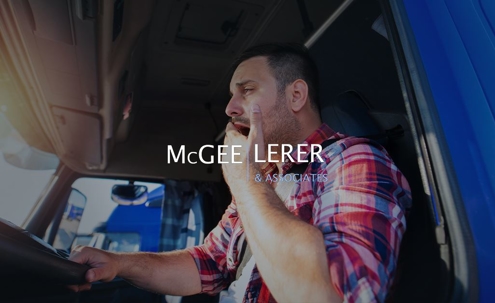 Sleepy truck driver is yawning while driving