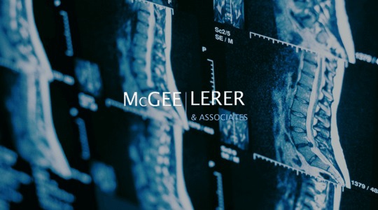 An MRI scan of a spine with the text "McGee, Lerer & Associates" overlaid.
