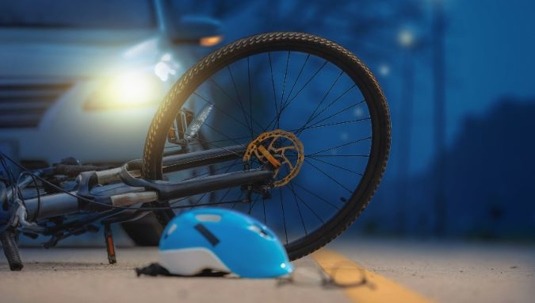 A bicycle lies in the road after an accident.