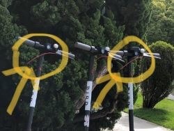 A close-up shows three electric scooters.
