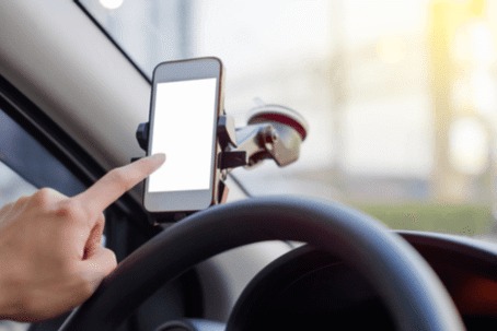 A person's finger touches the phone screen.