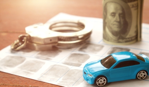Traffic court handles cases related to violations of traffic laws such as speeding, reckless driving, and DUI. Car and police handcuff on fingerprint crime page file.