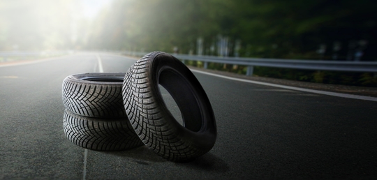 Summer tires on a road winter wheel off. Change a car seasonal tyre summer forest road with trees background. Change for winter tire. Banner Selling off. Or Background automechanic