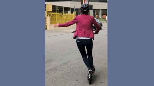 hand turning signal by the scooter rider