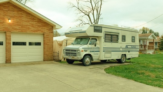 A motorhome is parked on a driveway
