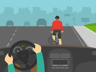 view from a car approaching a cyclist