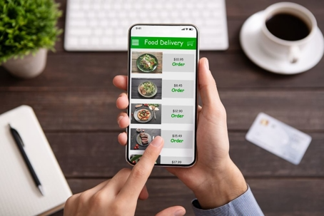 A person orders food delivery using their smartphone.