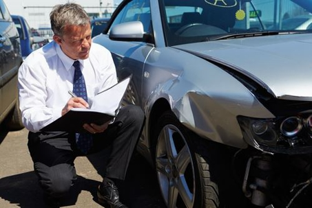 man checking the damage of the car