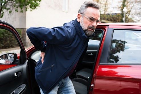 injured man getting out of car after car accident