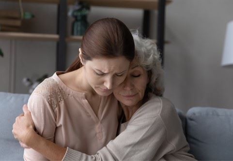 two women grieving the loss of a loved one